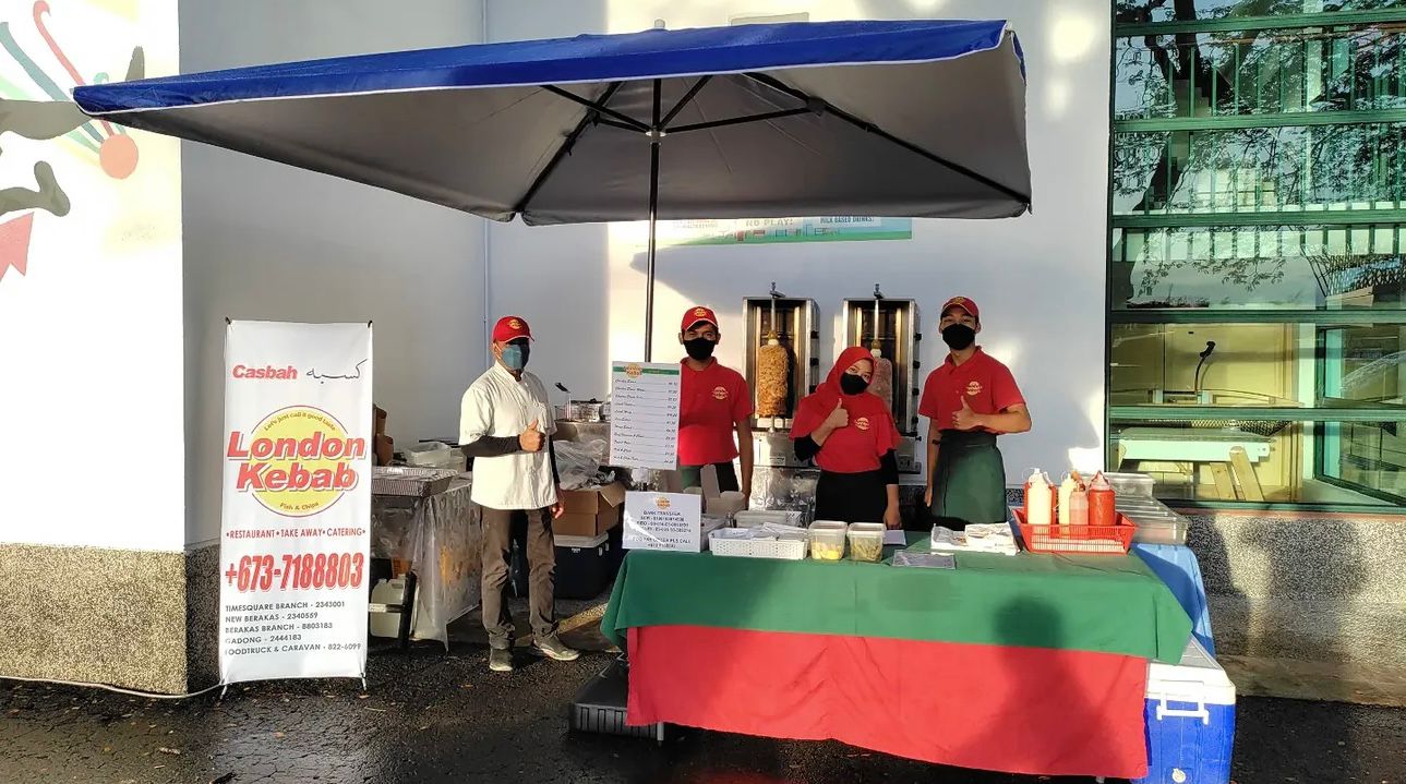 CASBAH catering stall setup at an event with staff and a branded display
