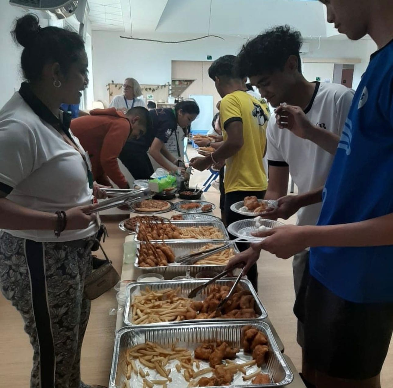 CASBAH catering buffet spread with guests serving freshly made fish & chips, kebabs and sides