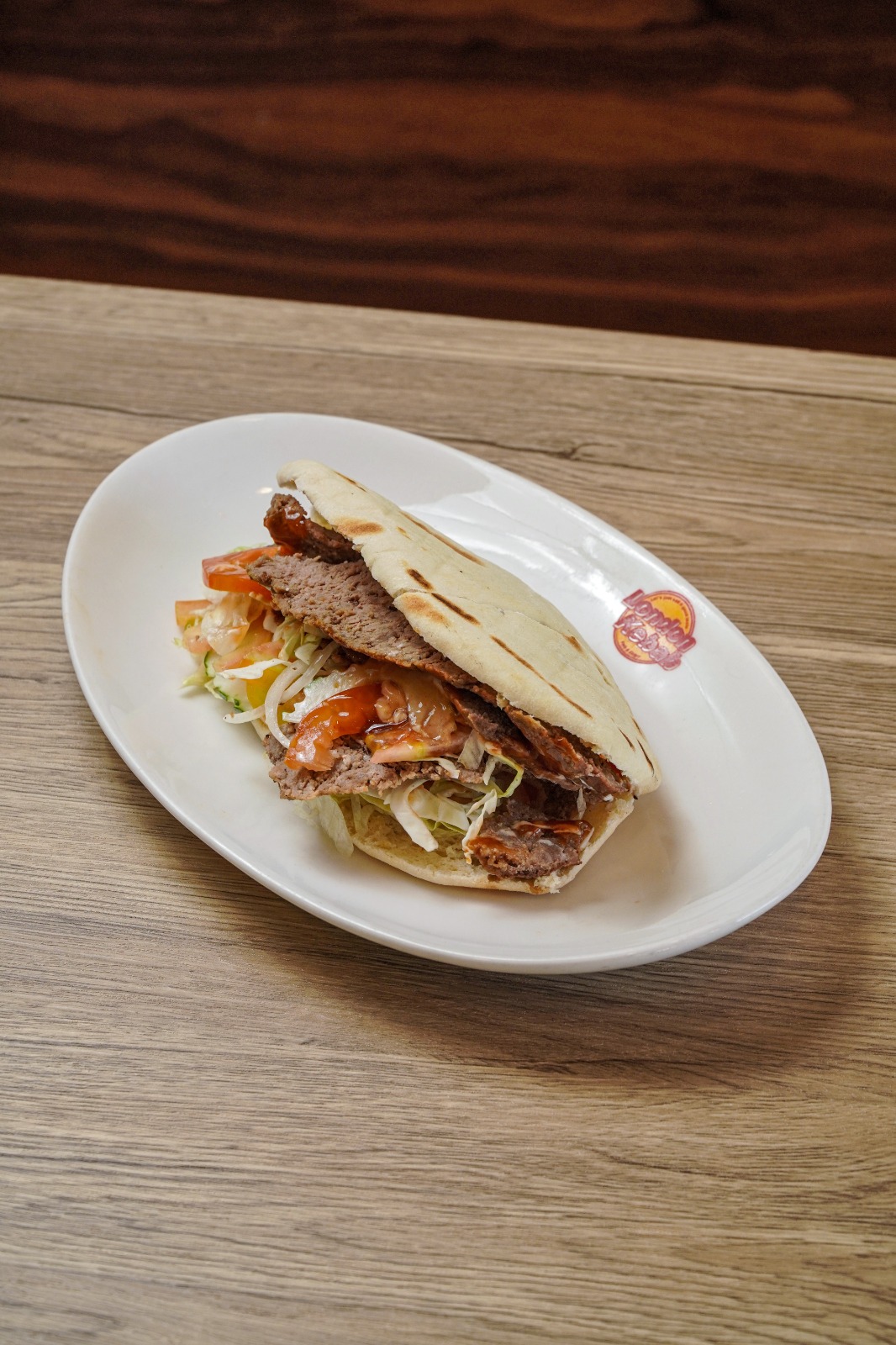 Doner kebab in warm pita bread with fresh salad